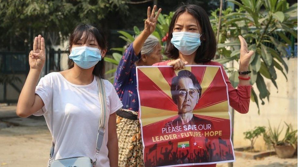 Demonstrators with an image of detained leader Aung San Suu Kyi in Mandalay (EPA)